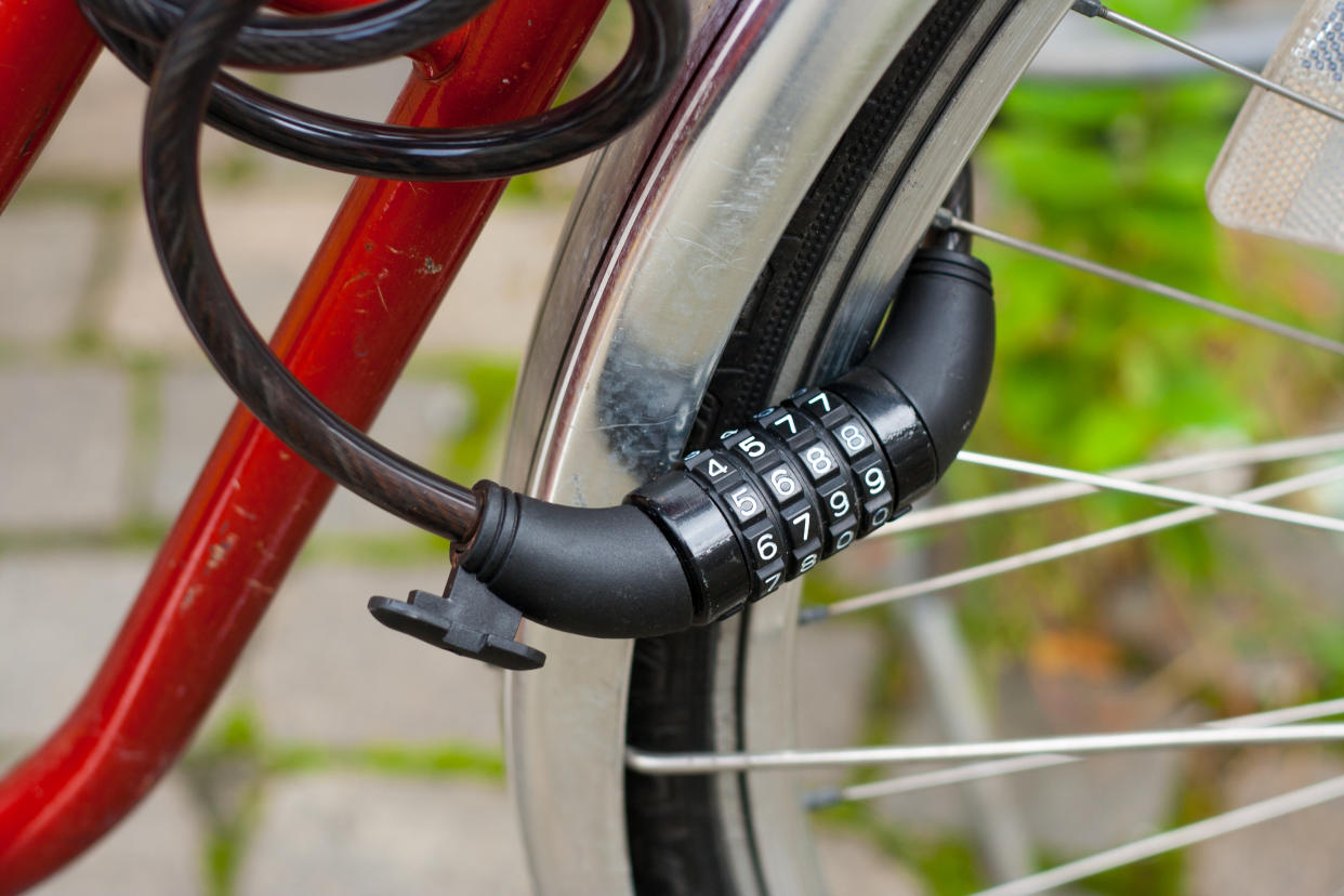 A combination bike lock on a red bike