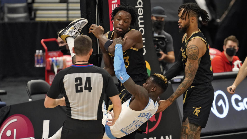 Toronto Raptors forward OG Anunoby (3) throws Los Angeles Lakers guard Dennis Schroder (17) to the floor after a foul during the first half of an NBA basketball game Tuesday, April 6, 2021, in Tampa, Fla. Both players were ejected after a brief scuffle. Looking on is guard Gary Trent Jr. (33) (AP Photo/Chris O'Meara)