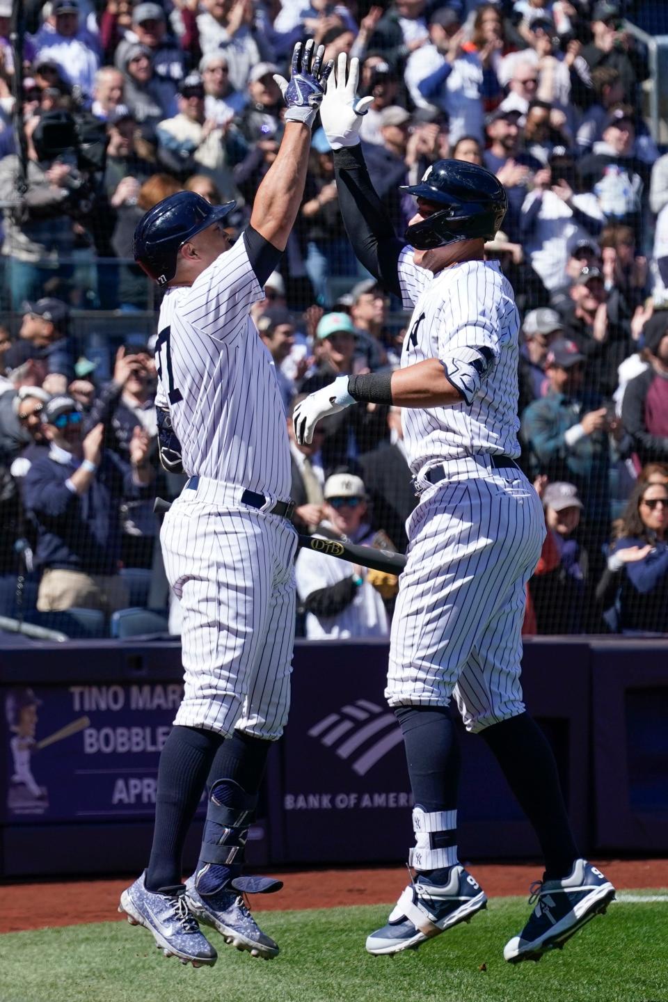 New York Yankees' Aaron Judge, right, celebrates his solo home run with Giancarlo Stanton (27) during the first inning of a baseball game against the San Francisco Giants at Yankee Stadium Thursday, March 30, 2023, in New York. (AP Photo/Seth Wenig)