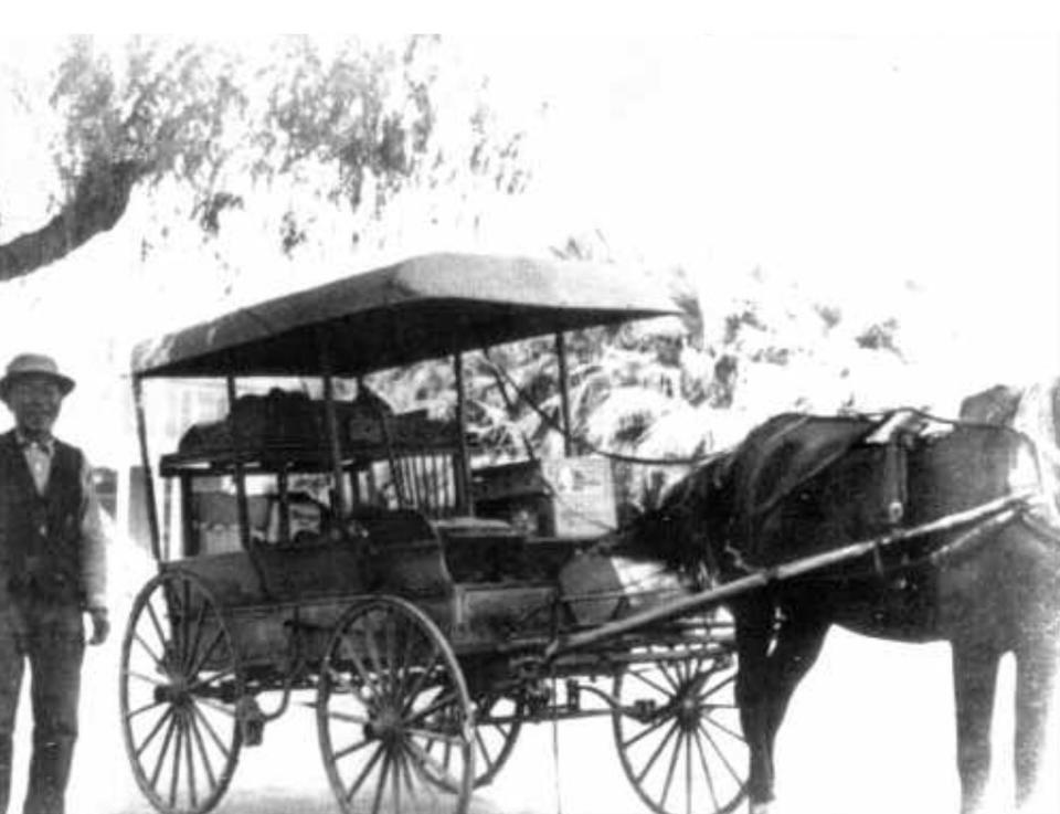 Dea Hong Toy standing next to his wagon. Upon moving to the Valley, Toy worked as a vegetable peddler delivering produce to various businesses.