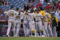 Oakland Athletics players celebrate a win over the Los Angeles Angels in a baseball game Sunday, Sept. 19, 2021, in Anaheim, Calif. (AP Photo/Jae C. Hong)