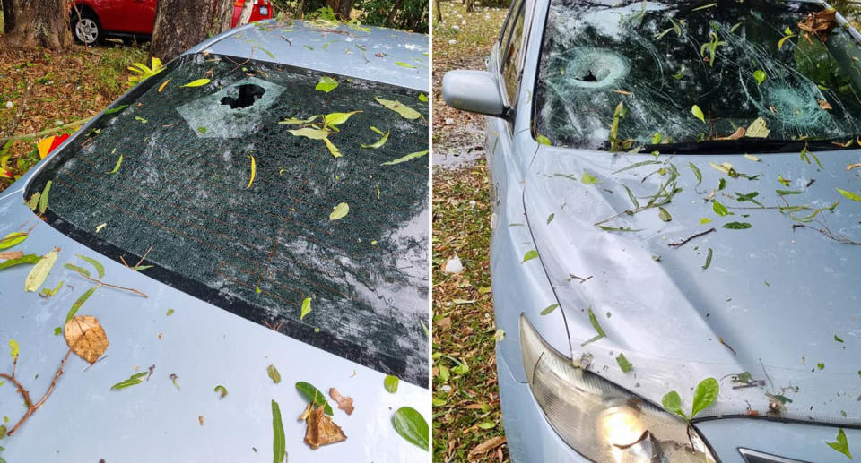 A Toyota is pictured with a smashed windscreen and back window after giant hail fell in the Mackay region.