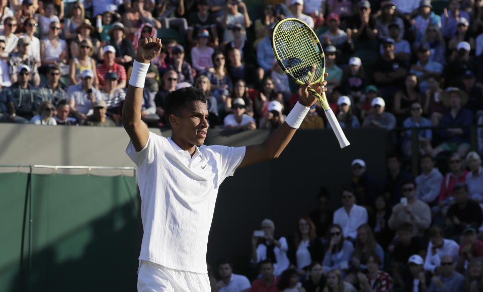 Canada's Felix Auger-Aliassime celebrates after beating Corentin Moutet of France in a Men's singles match during day three of the Wimbledon Tennis Championships in London, Wednesday, July 3, 2019. (AP Photo/Kirsty Wigglesworth)