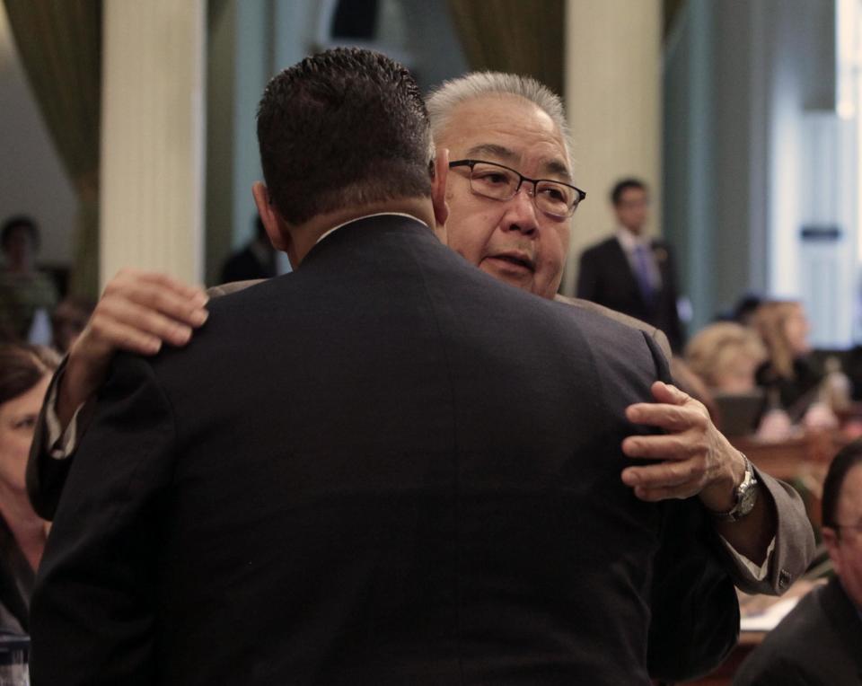 Assemblyman Warren Furutani, D-Lakewood, right, receives a congratulatory hug from Assembly Speaker John Perez, D-Los Angeles, after his pension reform bill was approved by the Assembly at the Capitol in Sacramento, Calif., Friday, Aug. 31, 2012. The measure, AB340, a sweeping pension compromise plan negotiated by Gov. Jerry Brown and Democratic legislative leaders, was approved by a 49-8 vote. (AP Photo/Rich Pedroncelli)