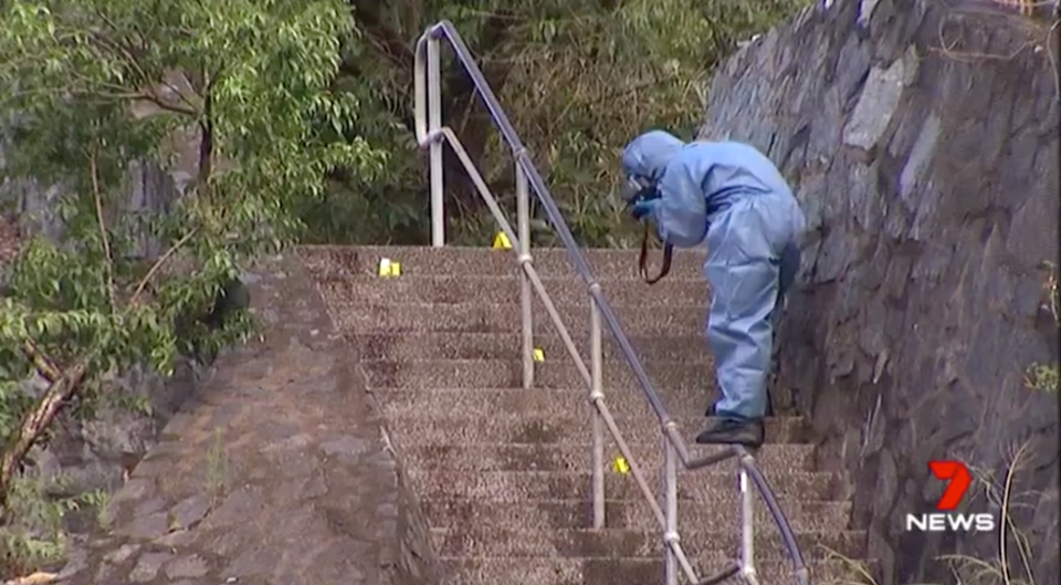 A forensic investigator takes photos at the crime scene in November 2013. Source: 7News