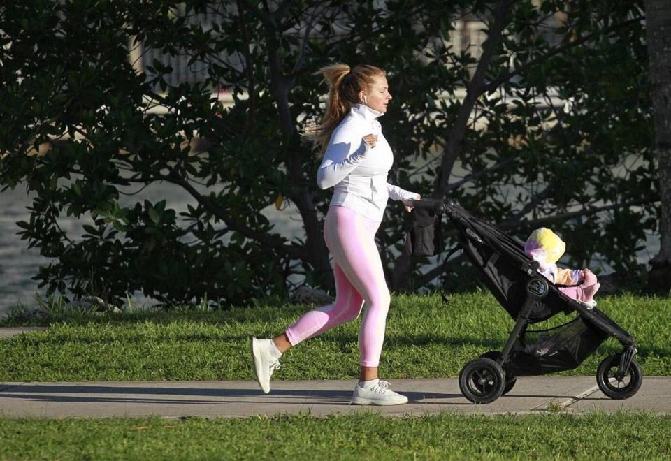 Residents of Miami’s Edgewater neighborhood stroll with friends, pets, and children at Margaret Pace Park wearing hoodies, sweaters, and cool weather attire as seasonal cool air arrived in South Florida on Tuesday, Dec. 1, 2020.