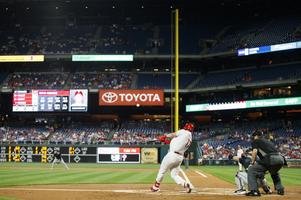 Philadelphia Phillies' Rhys Hoskins hits an RBI sacrifice fly off Miami Marlins starting pitcher Pablo Lopez during the first inning of a baseball game, Friday, Sept. 27, 2019, in Philadelphia. (AP Photo/Matt Slocum)