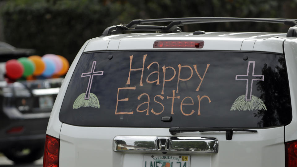 An Easter wish is displayed on a car as it drives through the streets in a neighborhood Saturday, April 11, 2020, during an Easter bunny parade in Valrico, Fla. The community's annual Easter egg hunt and candy toss had to be canceled in an attempt to avoid spreading the coronavirus. (AP Photo/Chris O'Meara)
