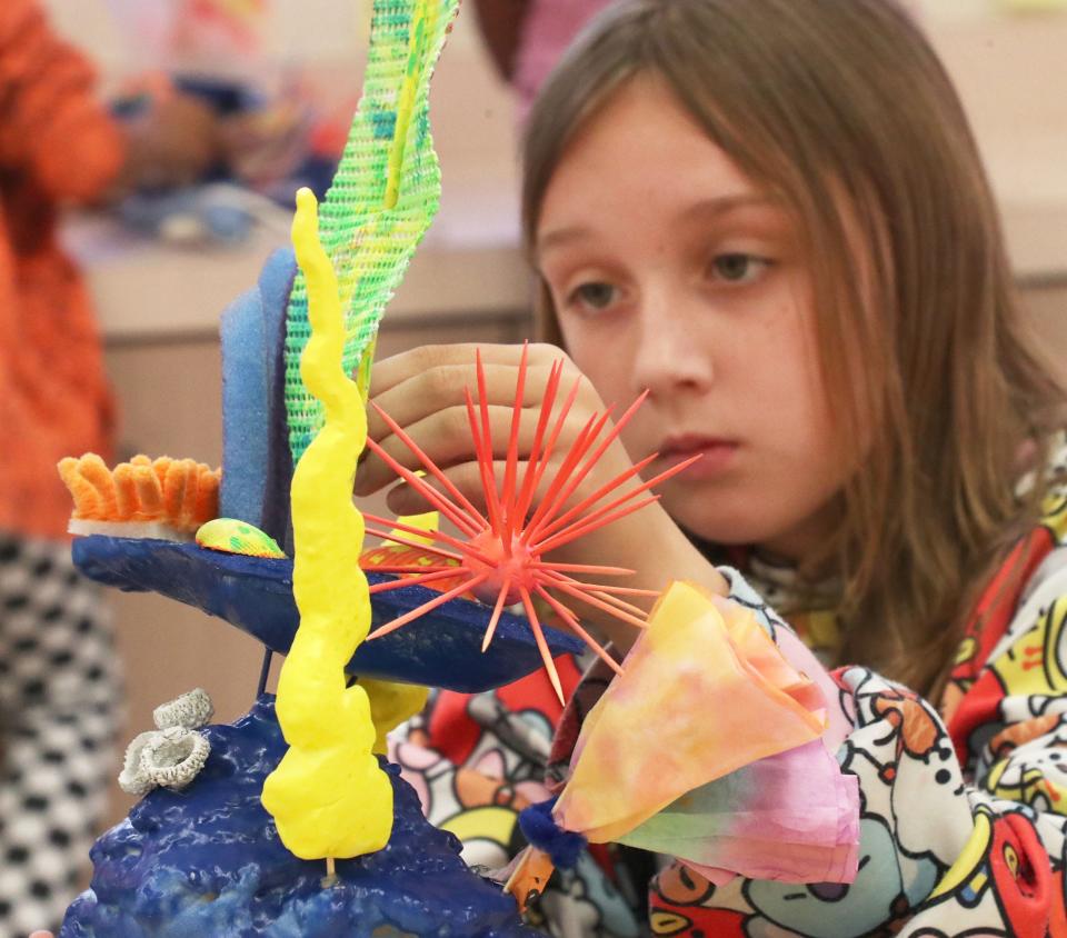 Fourth-grader Carlie Gibler builds a coral reef art project, Tuesday, Feb. 28, 2023, at South Daytona Elementary School.
