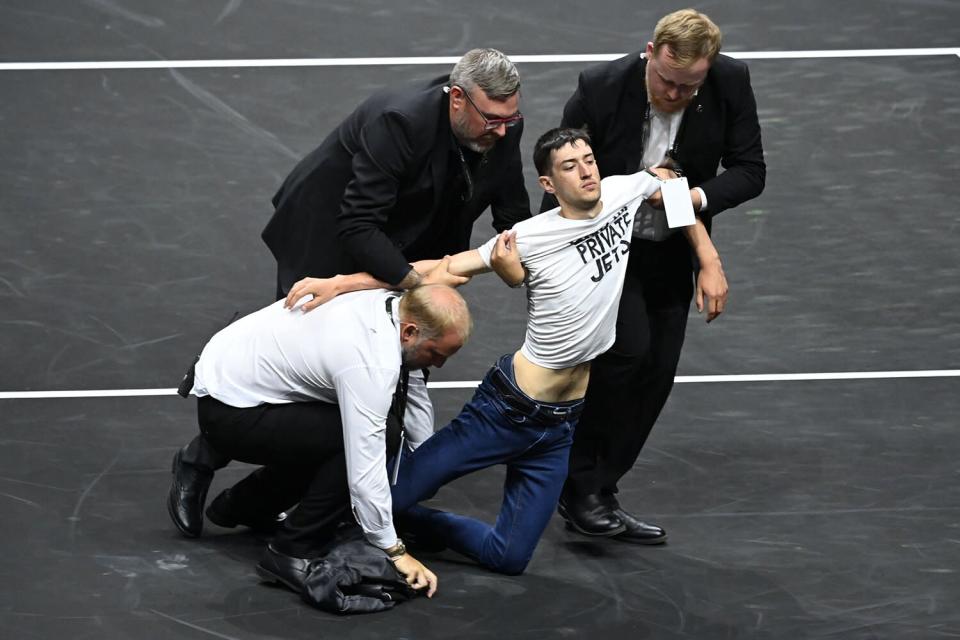 A protestor sets himself alight wearing a t-shirt saying 'End UK Private Jets' and is removed by security Laver Cup, Tennis Tournament, Day One, 02 Arena, London, UK - 23 Sep 2022