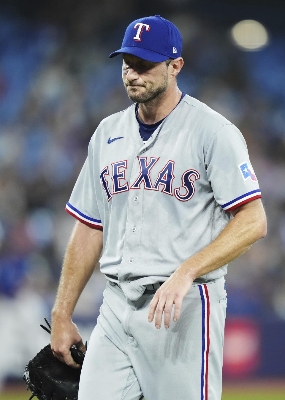 Texas Rangers starting pitcher Max Scherzer stretches his arm as he leaves the baseball game against the Toronto Blue Jays with an injury during the sixth inning Tuesday, Sept. 12, 2023, in Toronto. (Nathan Denette/The Canadian Press via AP)