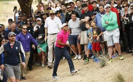 Tiger Woods hits out of the desert area on the par-5 3rd hole during the first round of the Waste Management Phoenix Open at TPC Scottsdale. Mandatory Credit: Rob Schumacher-Arizona Republic via USA TODAY Sports