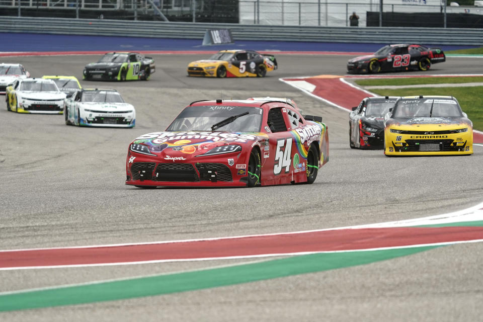 Kyle Busch (54) leads the field into Turn 13 during the NASCAR Xfinity Series auto race at the Circuit of the Americas in Austin, Texas, Saturday, May 22, 2021. (AP Photo/Chuck Burton)