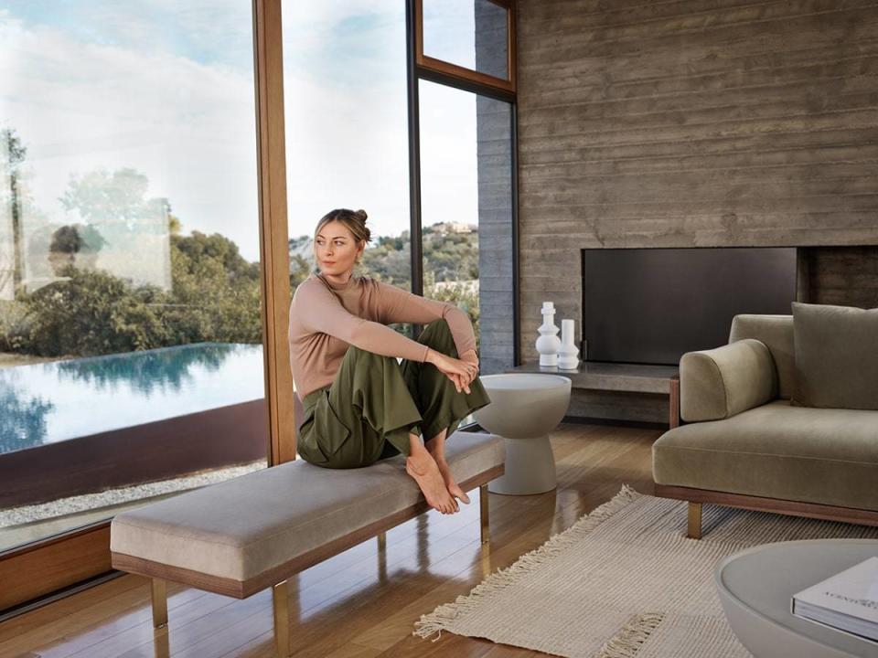 Tennis superstar Maria Sharapova sits on a new bench she designed in collaboration with Rove Concepts, all staged in her elegant LA home.