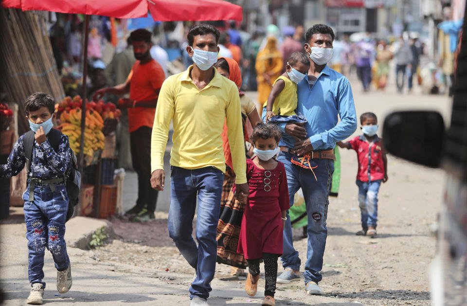 Indians wearing face masks as a precaution against the coronavirus walk at a bus station in Jammu, India, Friday, Sept. 11, 2020. By early May, 6.4 million people in India were likely infected by the coronavirus, said a study released Thursday, Sept. 10, by Indian scientists from the Indian Council of Medical Research, India’s apex medical research body and published in their in-house medical journal. At the time, India had detected around 35,000 cases and over a thousand deaths. But the results of India’s first nationwide study of prevailing infections in the country found that for every confirmed case that detected in May, authorities were missing between 82 and 130 infections. The study tested 28,000 people for proteins produced in response to the virus in the villages and towns across 70 districts in 21 Indian states between May 11 to June 14. (AP Photo/Channi Anand)