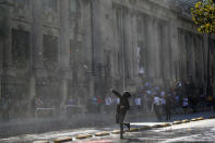 A demonstrator throws a bottle toward riot policemen during a protest calling for changes in the education system in Santiago, Chile April 11, 2017. REUTERS/Ivan Alvarado