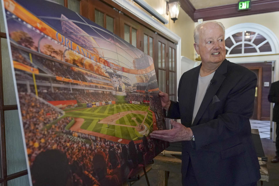 Former Orlando Magic basketball executive Pat Williams unveils renderings, at a news conference, of a proposed domed stadium that he hopes will bring an MLB baseball team to Central Florida, Tuesday, May 9, 2023, in Orlando, Fla. (AP Photo/John Raoux)