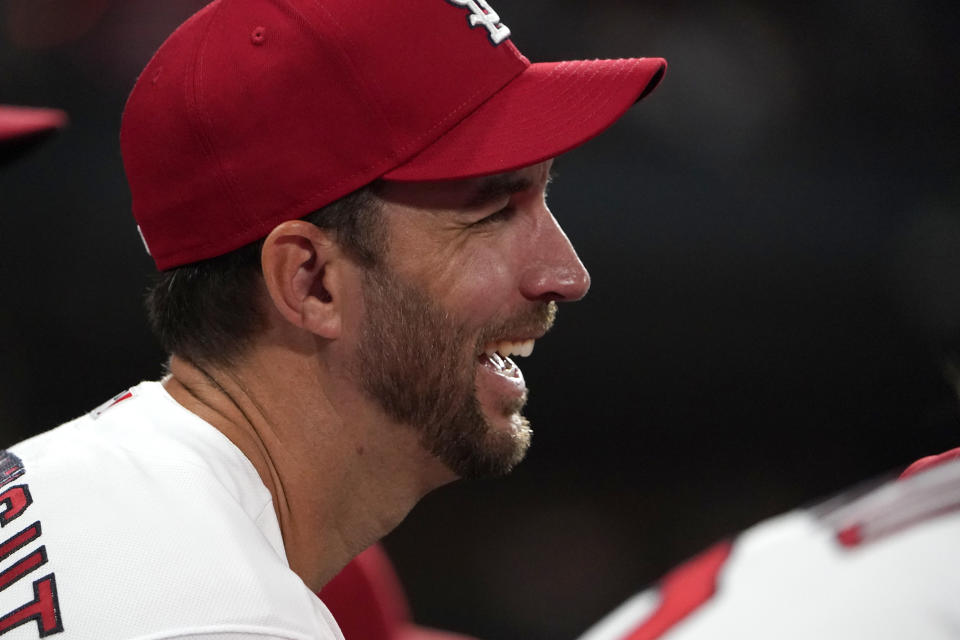 St. Louis Cardinals' Adam Wainwright smiles in the dugout during the third inning of a baseball game against the Chicago Cubs Friday, Oct. 1, 2021, in St. Louis. (AP Photo/Jeff Roberson)