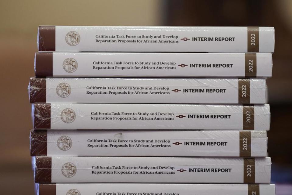 Copies of the interim report issued by California’s first-in-the-nation task force on reparations for African Americans are seen at the Capitol in Sacramento, Calif., Thursday, June 16, 2022. California Gov. Gavin Newsom vetoed a bill Thursday, Sept. 29, 2022, that would have granted more time for the reparations task force to complete it’s work at the request of Secretary of State Shirley Weber, who introduced the original reparation task force bill while a member of the state Assembly. The Coalition for a Just and Equitable California and other organizations sent a letter to Newsom saying the extension would send a demoralizing message to African Americans waiting for restitution.. (AP Photo/Rich Pedroncelli, File)