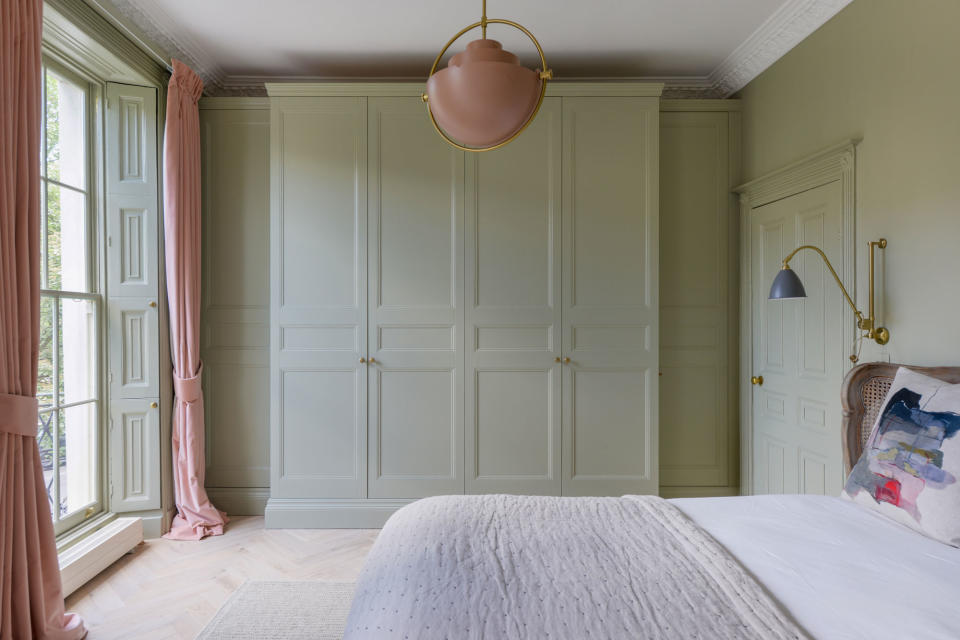 a bedroom painted in all sage green