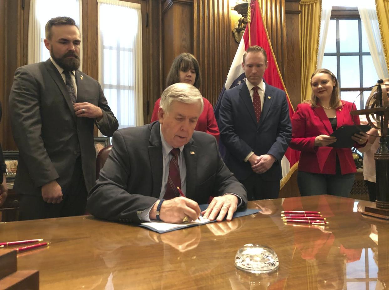 <span class="caption">Missouri Gov. Mike Parson signs a law in 2019 that includes a so-called 'trigger' provision to ban abortions if the U.S. Supreme Court overturned Roe v. Wade.</span> <span class="attribution"><a class="link " href="https://newsroom.ap.org/detail/AbortionMissouri/0004a620b93b4d55addfd4eba8ad79df/photo" rel="nofollow noopener" target="_blank" data-ylk="slk:AP Photo by Summer Balentine;elm:context_link;itc:0;sec:content-canvas">AP Photo by Summer Balentine</a></span>