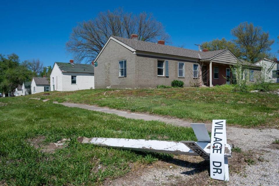 A street sign has toppled over in front of rundown houses at Clearview Village in De Soto.