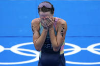 Flora Duffy of Bermuda celebrates after crossing the finish line to win the gold medal in the women's individual triathlon competition at the 2020 Summer Olympics, Tuesday, July 27, 2021, in Tokyo, Japan. (AP Photo/David Goldman)