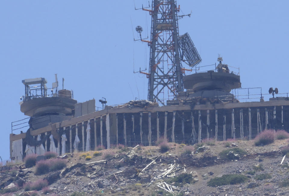 FILE - A damaged Israeli military position targeted by Hezbollah fighters is seen on the top of Mount Hermon in the Israeli-controlled Golan Heights, where the borders between Israel, Syria and Lebanon meet, is seen from Chebaa, a Lebanese town near the border with Israel, south Lebanon, June 26, 2024. U.S., European and Arab mediators are pressing to keep stepped-up cross-border attacks between Israel and Lebanon’s Hezbollah militants from spiraling into a nightmare Middle East-wide war that the world has feared for months. (AP Photo/Hussein Malla, File)