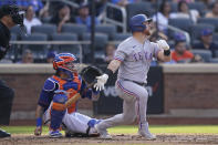 Texas Rangers' Kole Calhoun hits a solo home run off New York Mets' Trevor Williams in the fourth inning of a baseball game, Saturday, July 2, 2022, in New York. (AP Photo/John Minchillo)