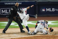 New York Yankees' Rougned Odor falls into the home plat umpire after running past Houston Astros catcher Martin Maldonado to score during the sixth inning of a baseball game Tuesday, May 4, 2021, in New York. (AP Photo/Frank Franklin II)