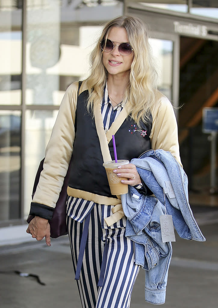 <p>King obviously needed to drink more of her iced coffee to get started during her visit to the L.A. airport. She forgot to take the tag off her new denim jacket. (Photo: Splash News) </p>