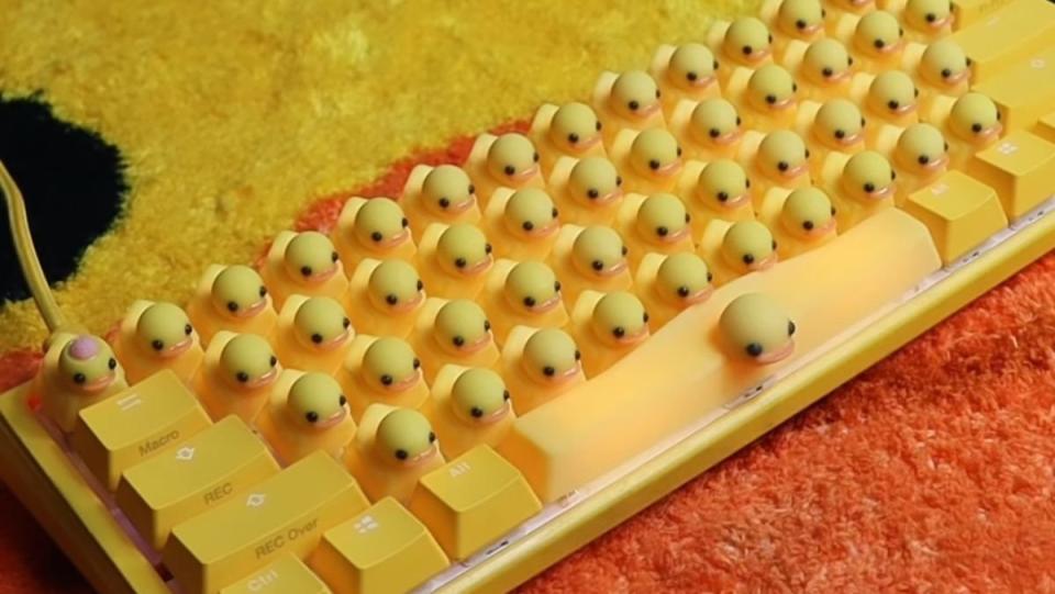 A keyboard with yellow rubber duck keycaps