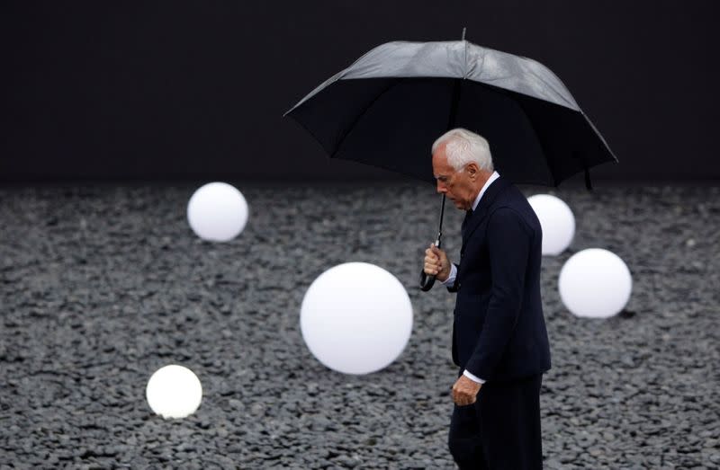 FILE PHOTO: Armani brand founder Giorgio Armani walks outside the venue for his fashion show in Beijing