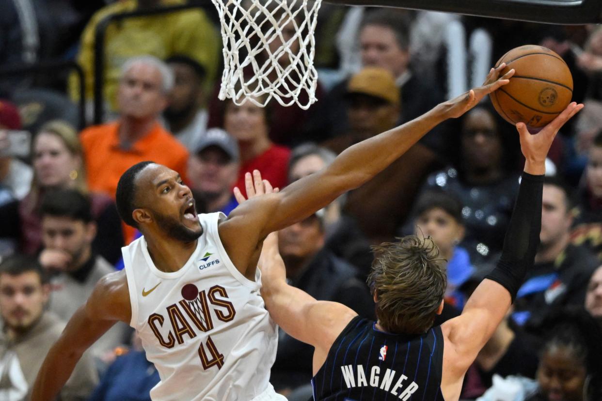 Cavaliers forward Evan Mobley defends a shot by Orlando Magic center Moritz Wagner in the third quarter, Feb. 22, 2024, in Cleveland.