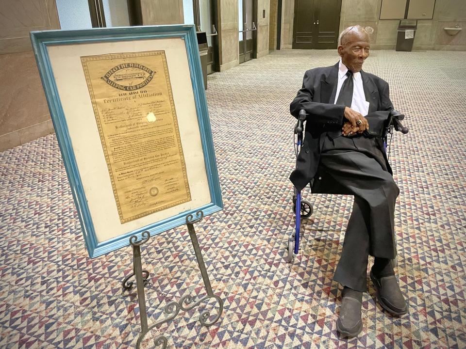 Sollie Mitchell, a former Pullman porter, sits in the A. Philip Randolph Room in September at the Prime Osborn Convention Center, next to a document signed by Randolph in 1936 to create the local chapter of the Brotherhood of Sleeping Car Porters.