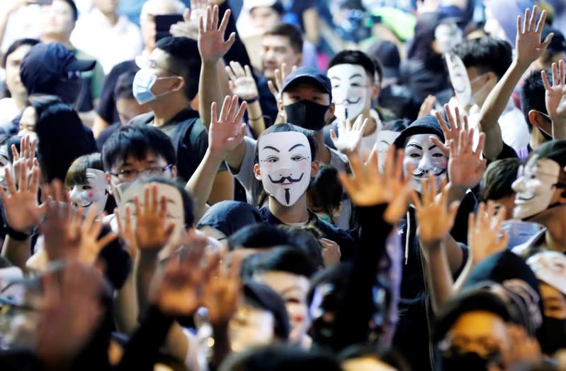 Protesters wearing Guy Fawkes masks attend an anti-government demonstration in Hong Kong