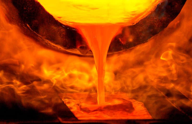 FILE PHOTO: Melted gold flows out of a smelter into a mould of a bar at a plant of gold refiner and bar manufacturer Argor-Heraeus SA in the southern Swiss town of Mendrisio