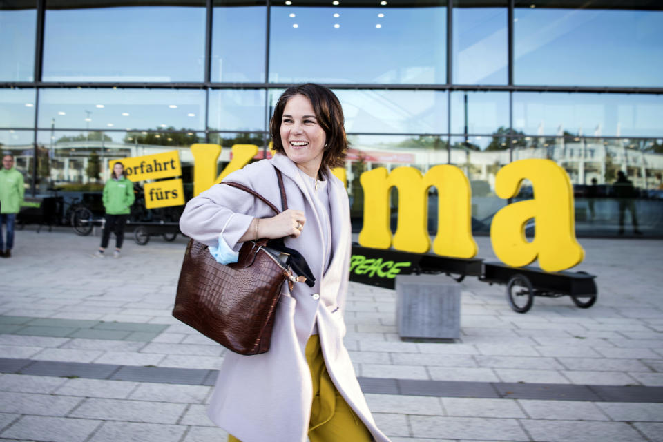 Annalena Baerbock, co-chairwoman of the German Green party (Die Gruenen), leaves after talks with the SPD, FDP and Green party in Berlin, Thursday, Oct. 7, 2021. Germany's center-left Social Democrats and two smaller parties said Thursday they will deepen their talks next week on forming a new government, as the leader of outgoing Chancellor Angela Merkel's bloc indicated his willingness to step aside following its election defeat. (AP Photo/Steffi Loos)