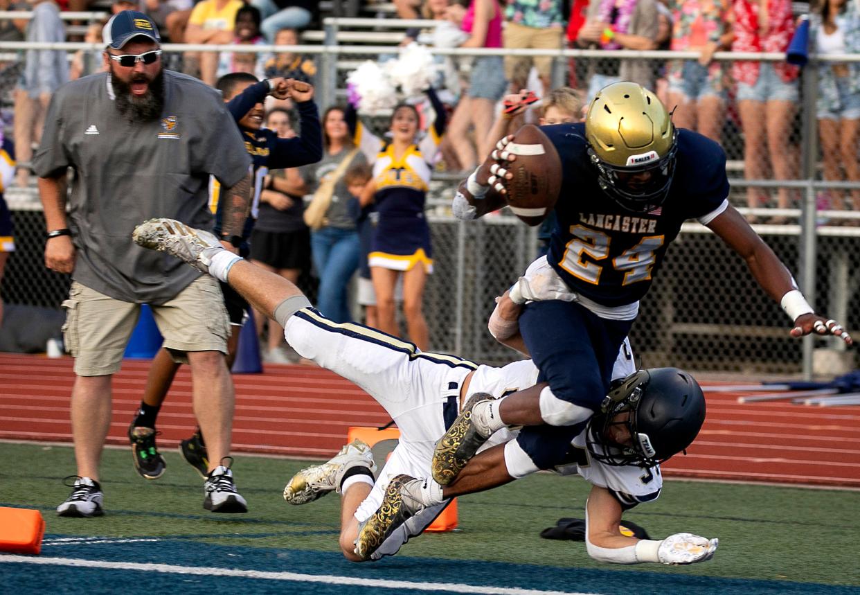 Lancaster's Gunner Richards (24) takes the ball in for a touchdown against Teays Valley during Division I High School football at Fulton Field on August 18, 2023, in Lancaster, Ohio.