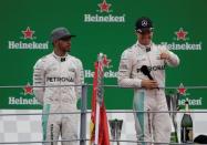 Formula One - F1 - Italian Grand Prix 2016 - Autodromo Nazionale Monza, Monza, Italy - 4/9/16 Mercedes' Nico Rosberg celebrates his win on the podium after the race as Lewis Hamilton looks on Reuters / Max Rossi Livepic