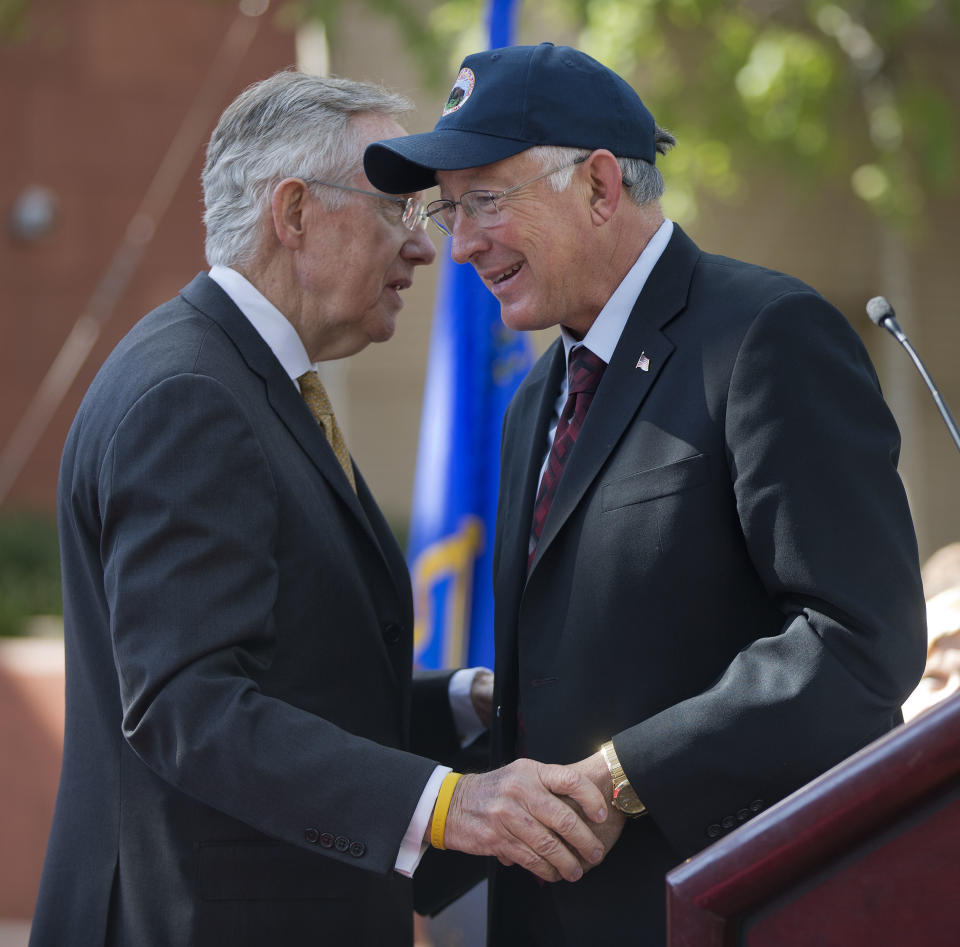 Interior Secretary Ken Salazar, right, and Senate Majority Leader Harry Reid talk, Friday, Oct. 12, 2012, in Las Vegas, after a news conference in which they announced a plan that sets aside 285,000 acres of public land for the development of large-scale solar power plants. The government is establishing 17 new "solar energy zones" on 285,000 acres in six states: California, Nevada, Arizona, Utah, Colorado and New Mexico. Most of the land,153,627 acres, is in Southern California. (AP Photo/Julie Jacobson)