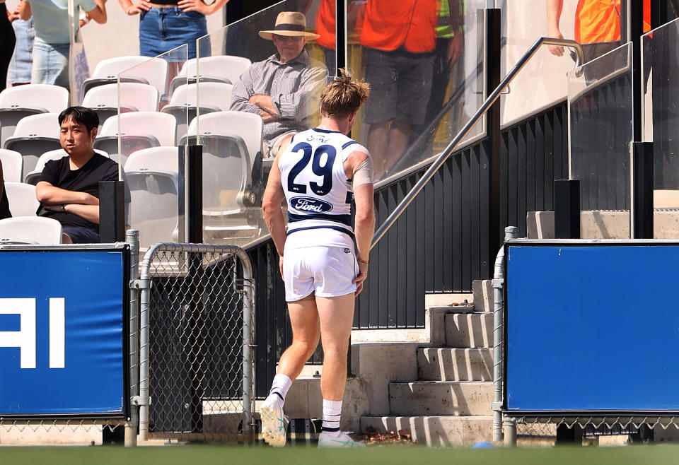 MELBOURNE, AUSTRALIA - FEBRUARY 22: Cam Guthrie of the Cats leaves the field after sustaining an injury during an AFL practice match between Carlton Blues and Geelong Cats at Ikon Park on February 22, 2024 in Melbourne, Australia. (Photo by Kelly Defina/Getty Images)