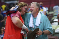 Ryan Crouser, of United States, holds a sign while celebrating winning the gold medal in the final of the men's shot put with his father and coach, Mitch Crouser, at the 2020 Summer Olympics, Thursday, Aug. 5, 2021, in Tokyo, Japan. (Matthias Hangst/Pool Photo via AP)