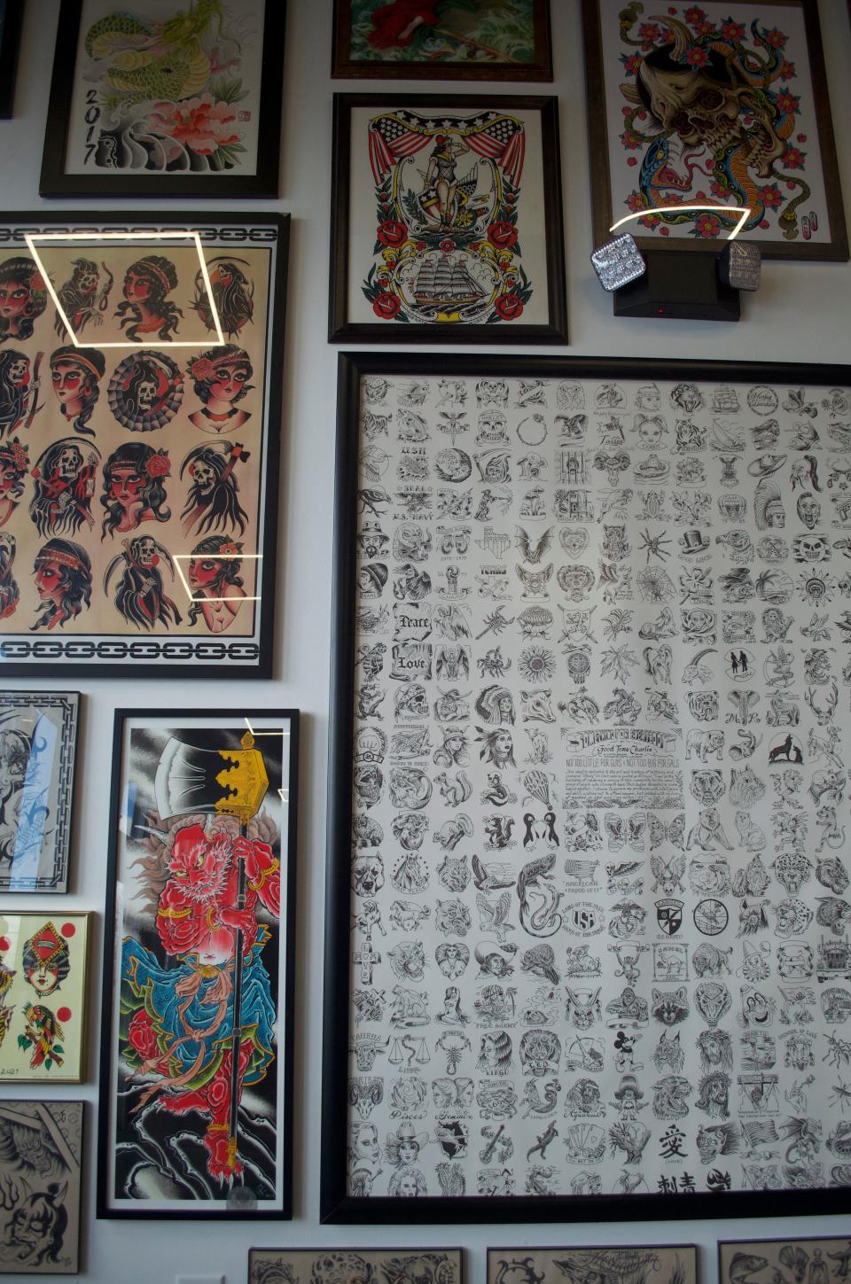 A wall of tattoo artwork at Spilt Milk Mooncusser Tattoo in West Yarmouth.