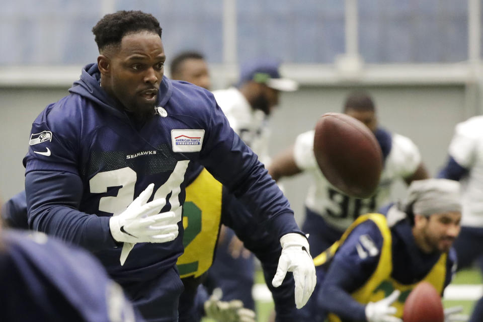 Seattle Seahawks running back Robert Turbin tosses a football as he warms up before NFL football practice, Friday, Dec. 27, 2019, in Renton, Wash. (AP Photo/Ted S. Warren)