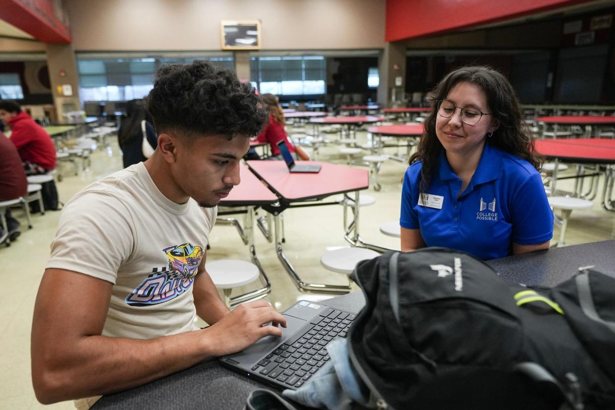 Jonathan Arias fills out the FAFSA with College Possible's Abrianna Citta at last week's Travis High event.