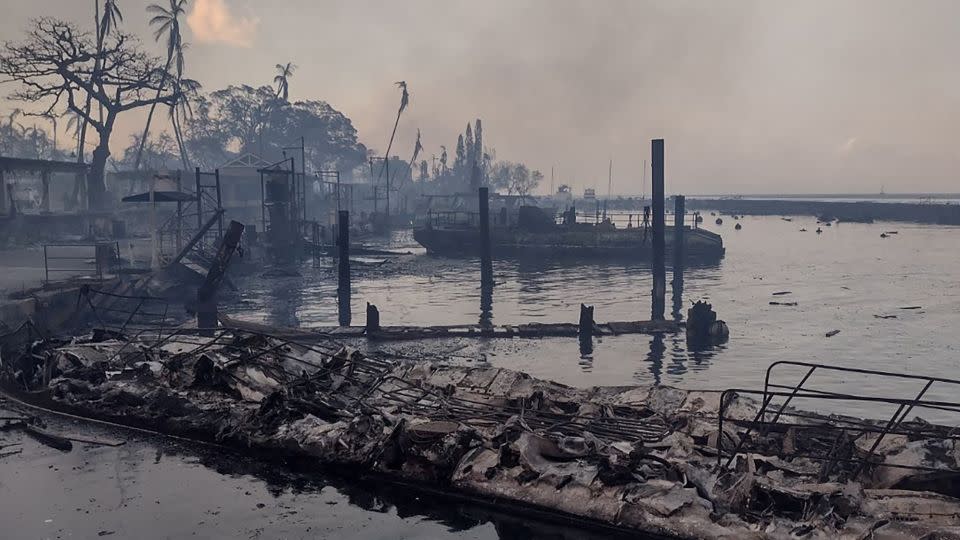 A charred boat lies in the scorched waterfront after wildfires devastated Maui's city of Lahaina on August 9, 2023. - From Mason Jarvi/Reuters