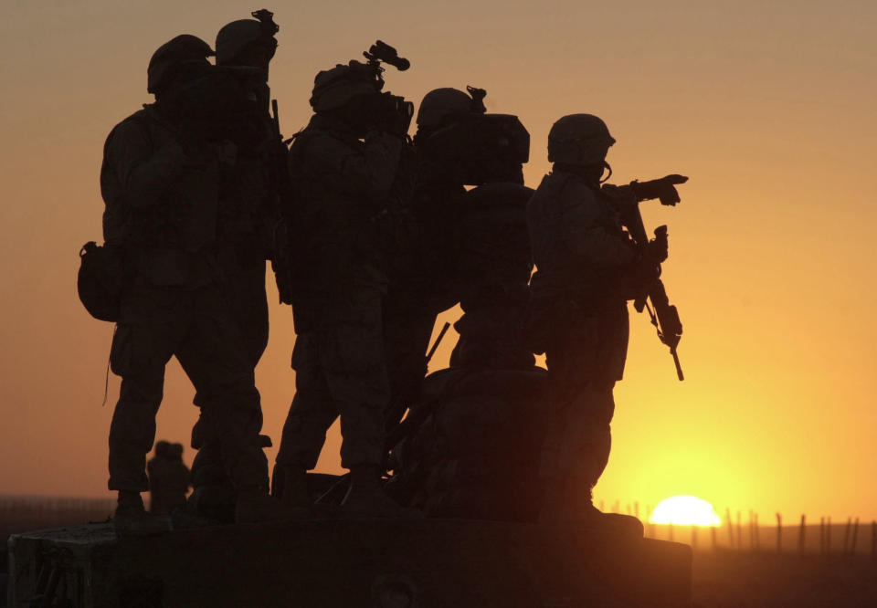 FILE - In this Jan. 14, 2002 file photo, U.S. Marines scan the northwest perimeter of the American military compound at Afghanistan's Kandahar airport using sophisticated thermal imagery equipment. The Biden administration’s surprise announcement in April 2021, of an unconditional troop withdrawal from Afghanistan by Sept. 11, 2021, appears to strip the Taliban and the Afghan government of considerable leverage, pressuring them to reach a peace deal. (AP Photo/Marco Di Lauro, File)