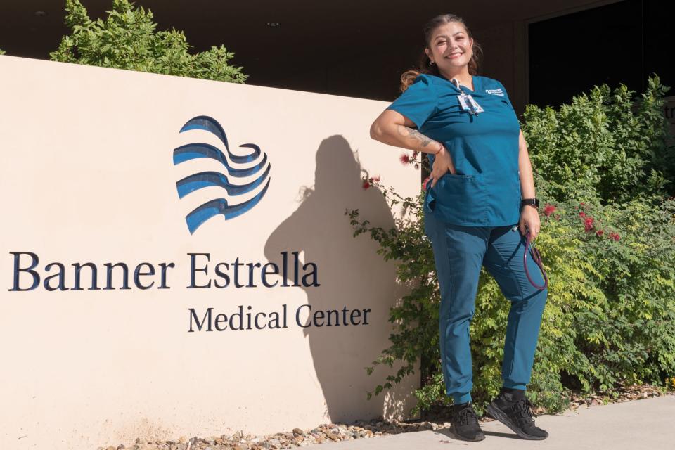 Alejandra Aguilar, a single mother who is studying to be a nurse, poses in front of Banner Estrella which is where she is completing her clinicals on Friday, Nov. 5 in Phoenix.