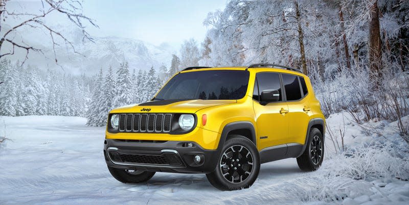 A yellow Jeep Renegade parked in a snowy mountain scene